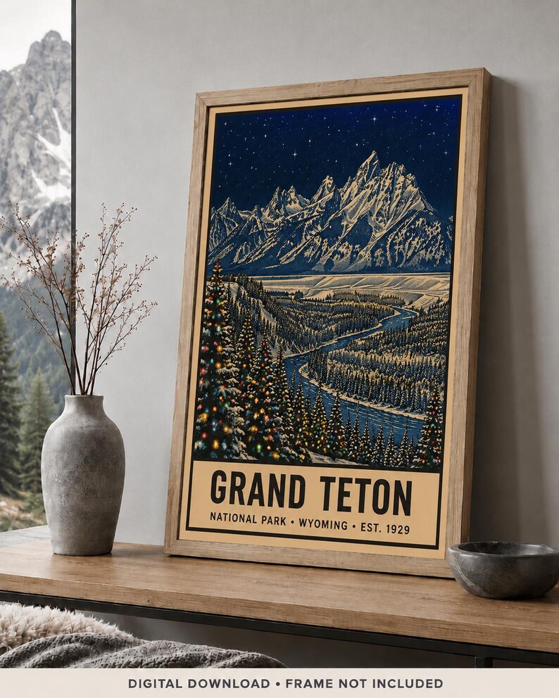 May include: A framed vertical poster featuring a nighttime illustration of the Grand Teton mountain range under a starry sky. The scene includes a winding river, snow-covered pine trees with colorful lights, and text reading GRAND TETON NATIONAL PARK WYOMING EST. 1929.