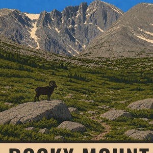 May include: A poster illustration of a bighorn sheep standing on a large rock in a green alpine meadow. In the background, jagged, snow-capped grey mountains rise against a clear blue sky. The text ROCKY MOUNT is visible at the bottom of the print.