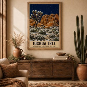 May include: A framed wall art print featuring a night landscape of Joshua Tree National Park with a starry sky, rock formations, and desert vegetation. The text at the bottom reads JOSHUA TREE NATIONAL PARK CALIFORNIA EST. 1994.