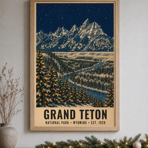 May include: A framed vertical poster featuring a night landscape of the Grand Teton mountains under a starry sky. The scene includes a winding river and snow-covered pine trees decorated with colorful lights. Text reads GRAND TETON NATIONAL PARK WYOMING EST. 1929.