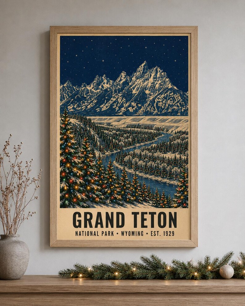 May include: A framed vertical poster featuring a night landscape of the Grand Teton mountains under a starry sky. The scene includes a winding river and snow-covered pine trees decorated with colorful lights. Text reads GRAND TETON NATIONAL PARK WYOMING EST. 1929.