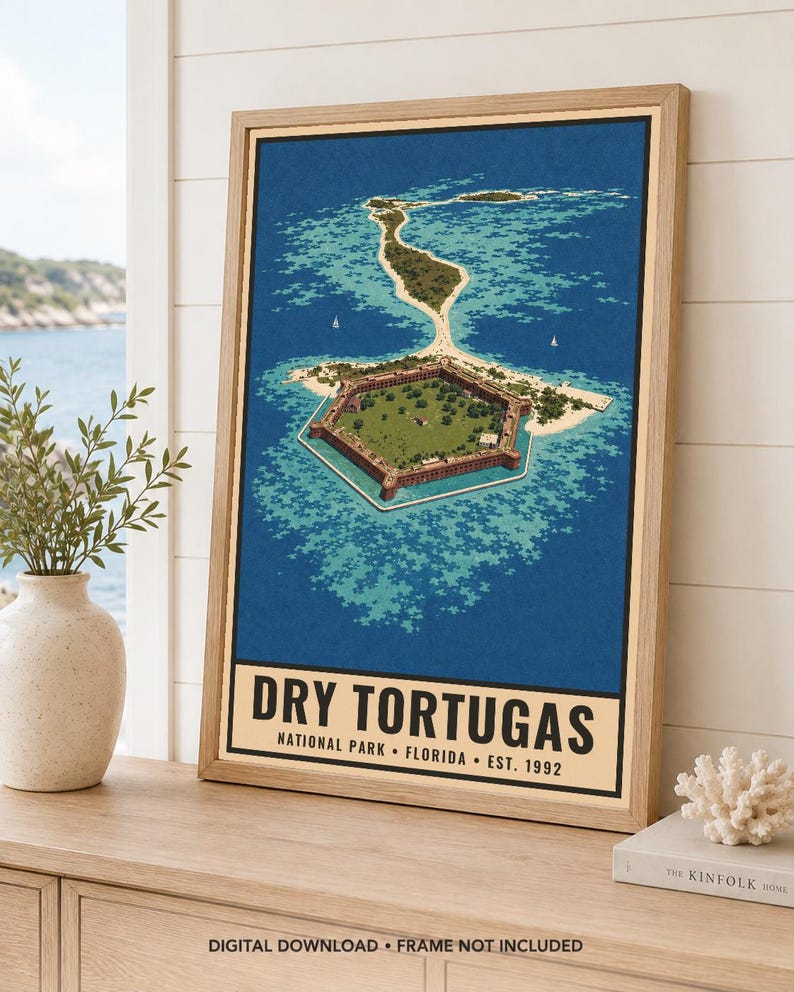 May include: A framed vertical poster featuring an aerial illustration of the hexagonal Fort Jefferson surrounded by turquoise water and sandy islands. The text at the bottom reads DRY TORTUGAS NATIONAL PARK FLORIDA EST. 1992 in black lettering.