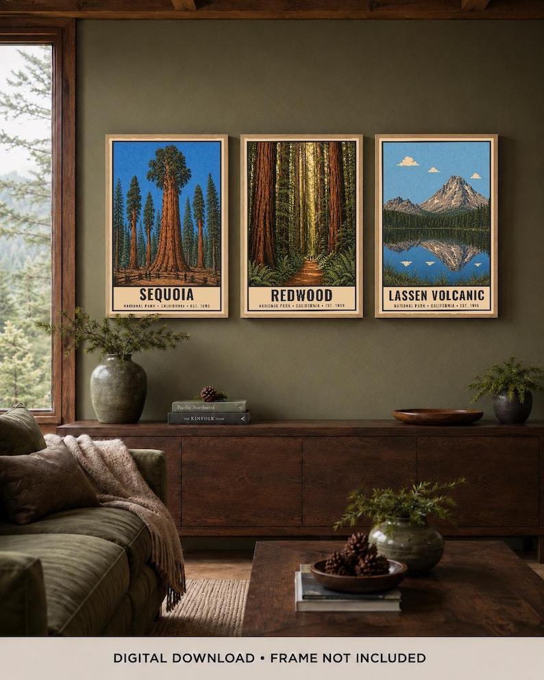May include: Three vertical wall art prints featuring illustrations of California National Parks. The left print shows Sequoia trees, the center print depicts a Redwood forest path, and the right print displays Lassen Volcanic mountain and lake.