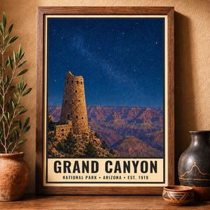 May include: A framed vertical poster featuring a night sky over the Grand Canyon and the Desert View Watchtower. The text reads GRAND CANYON NATIONAL PARK ARIZONA EST. 1919. The image displays a stone tower against a starry blue sky and canyon.