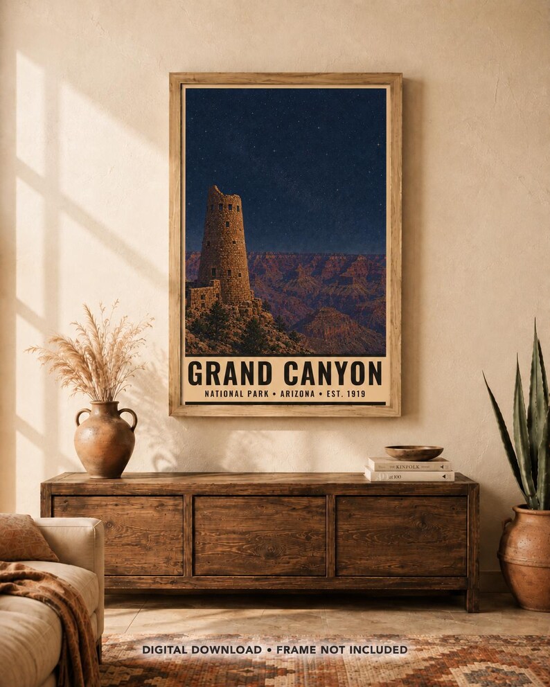 May include: A rectangular wall art print featuring a night scene of the Grand Canyon with a stone watchtower under a starry sky. The text reads GRAND CANYON NATIONAL PARK ARIZONA EST. 1919. The print is displayed in a light wood frame.