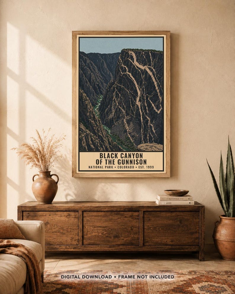 Op de afbeelding: Een verticale wandkunstprint met een gestileerde illustratie van het Black Canyon of the Gunnison National Park in Colorado, met donkere rotsachtige kliffen, een rivier en de tekst Black Canyon of the Gunnison National Park Colorado Est. 1999.