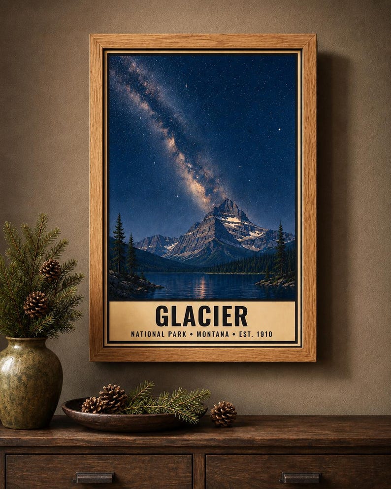 May include: A framed vertical wall art print featuring a night landscape of a mountain range and a lake under a starry sky with the Milky Way. The text at the bottom reads GLACIER NATIONAL PARK MONTANA EST. 1910 in black capital letters.