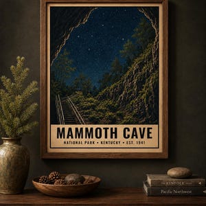 May include: A framed wall art print featuring a night scene of Mammoth Cave National Park in Kentucky. The image shows a starry sky above a rocky cave entrance with stairs, with the text MAMMOTH CAVE NATIONAL PARK KENTUCKY EST. 1941 below.