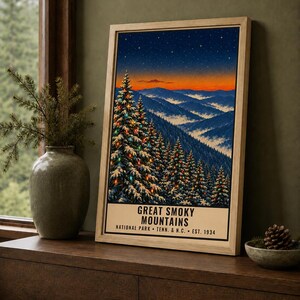 May include: A framed vertical poster featuring a snowy mountain landscape at twilight with evergreen trees decorated with colorful lights. The text reads GREAT SMOKY MOUNTAINS NATIONAL PARK TENN. & N.C. EST. 1934. The bottom text states DIGITAL DOWNLOAD.