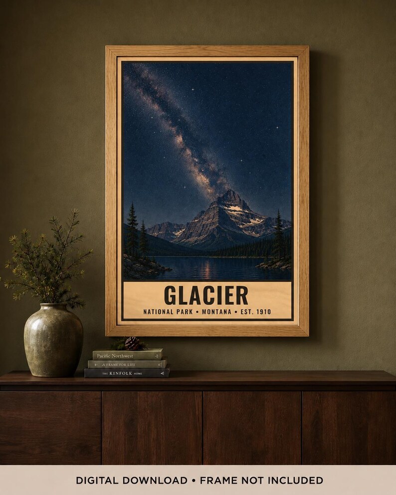 May include: A framed vertical poster featuring a night landscape of Glacier National Park in Montana. The image displays a mountain peak under a starry sky with the Milky Way, a lake, and pine trees. Text reads: GLACIER NATIONAL PARK MONTANA EST. 1910.