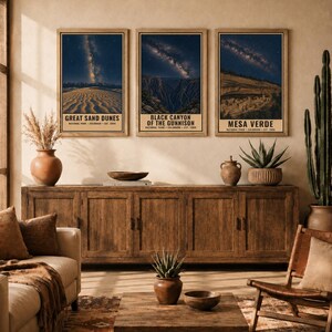 May include: Three rectangular wall art prints featuring night sky landscapes of Great Sand Dunes, Black Canyon of the Gunnison, and Mesa Verde National Parks. Each print displays a starry galaxy above the park terrain with text labels below.
