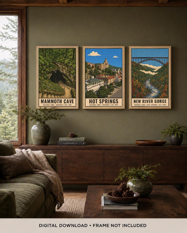 May include: Three vertical art prints in light wood frames featuring illustrations of Mammoth Cave, Hot Springs, and New River Gorge National Parks. Each print includes the park name, location, and establishment year in black text at the bottom.