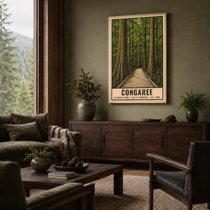 May include: A vertical rectangular wall art print featuring a forest scene with tall trees and a wooden boardwalk path. The text at the bottom reads CONGAREE NATIONAL PARK SOUTH CAROLINA EST. 2003. The print is displayed in a light wood frame.