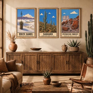 May include: Three rectangular wall art prints featuring illustrations of White Sands, Saguaro, and Petrified Forest National Parks. Each print displays a blue sky, landscape scenery, and the park name in bold black text at the bottom of the frame.