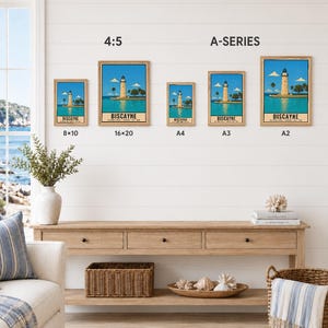 May include: Five framed posters of the Biscayne National Park lighthouse in various sizes labeled 8x10, 16x20, A4, A3, and A2. The artwork features a lighthouse on a coast with blue water and sky. Text reads Biscayne National Park, Florida, Est. 1968.