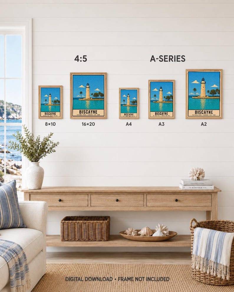 May include: Five framed posters of the Biscayne National Park lighthouse in various sizes labeled 8x10, 16x20, A4, A3, and A2. The artwork features a lighthouse on a coast with blue water and sky. Text reads Biscayne National Park, Florida, Est. 1968.