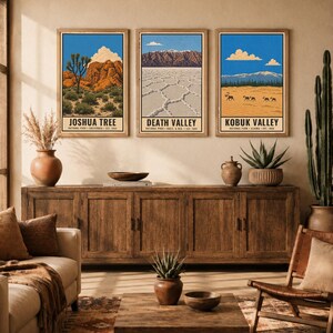 May include: Three rectangular wall art prints featuring illustrations of Joshua Tree, Death Valley, and Kobuk Valley National Parks. Each print displays a blue sky, landscape scenery, and the park name in black text at the bottom of the frame.