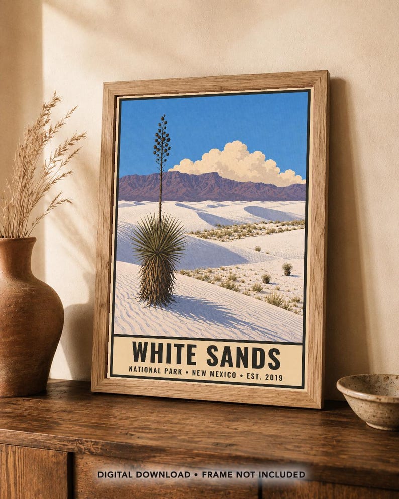 May include: A framed art print featuring a landscape illustration of White Sands National Park in New Mexico. The image displays white sand dunes, a yucca plant, distant mountains, and a blue sky with clouds. The text reads WHITE SANDS NATIONAL PARK NEW MEXICO EST. 2019.