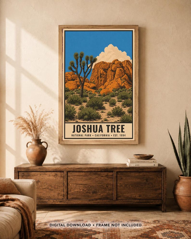 May include: A vertical wall art print featuring a desert landscape with a Joshua tree, orange rock formations, and a blue sky with a white cloud. The text at the bottom reads JOSHUA TREE NATIONAL PARK CALIFORNIA EST. 1994 in black capital letters.