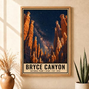 May include: A framed vertical poster featuring a night sky filled with stars above the orange rock hoodoos of Bryce Canyon. The text at the bottom reads BRYCE CANYON NATIONAL PARK &bull; UTAH &bull; EST. 1928 in black capital letters on a cream background.