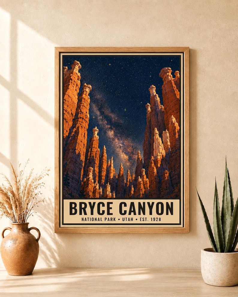 May include: A framed vertical poster featuring a night sky filled with stars above the orange rock hoodoos of Bryce Canyon. The text at the bottom reads BRYCE CANYON NATIONAL PARK &bull; UTAH &bull; EST. 1928 in black capital letters on a cream background.