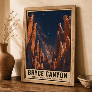 May include: A framed vertical poster featuring a night sky over Bryce Canyon National Park in Utah. The image displays tall orange rock hoodoos against a dark blue starry sky with a visible Milky Way. The text reads BRYCE CANYON NATIONAL PARK UTAH EST. 1928.