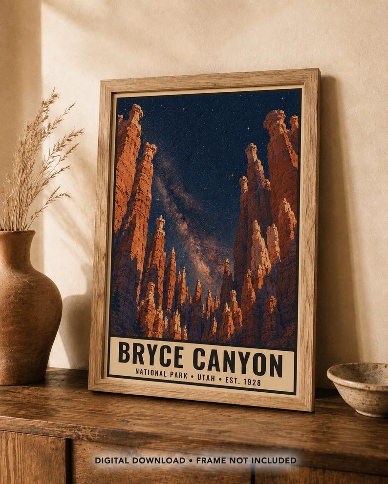 May include: A framed vertical poster featuring a night sky over Bryce Canyon National Park in Utah. The image displays tall orange rock hoodoos against a dark blue starry sky with a visible Milky Way. The text reads BRYCE CANYON NATIONAL PARK UTAH EST. 1928.