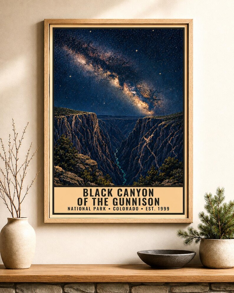 May include: A rectangular wall poster in a light wood frame featuring a night sky with a visible Milky Way galaxy above the deep, dark rock formations of the Black Canyon of the Gunnison. The text reads: BLACK CANYON OF THE GUNNISON NATIONAL PARK COLORADO EST. 1999.