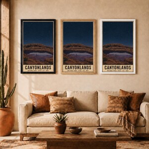 May include: Three vertical wall art prints featuring the Mesa Arch in Canyonlands National Park at night under a starry sky. Each print displays the text CANYONLANDS NATIONAL PARK UTAH EST. 1964. The prints are shown in black, wood, and white frames.