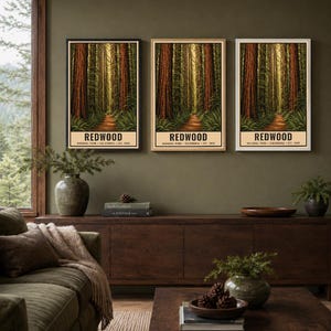 May include: Three vertical wall art prints featuring a Redwood National Park forest scene with tall trees and a dirt path. Each print includes the text REDWOOD NATIONAL PARK CALIFORNIA EST. 1968 at the bottom. The prints are displayed in black, wood, and white frames.