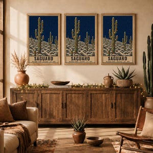May include: A set of three identical wall art prints featuring a desert landscape with Saguaro cacti decorated with string lights under a starry night sky. Each print includes the text SAGUARO NATIONAL PARK ARIZONA EST. 1994 at the bottom.