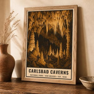 May include: A framed vertical poster featuring a sepia-toned illustration of the interior of Carlsbad Caverns, New Mexico. The text at the bottom reads: CARLSBAD CAVERNS NATIONAL PARK &bull; NEW MEXICO &bull; EST. 1930. The image depicts various stalactites and stalagmites.