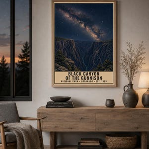 May include: A rectangular wall art print featuring a night sky filled with stars and the Milky Way galaxy above the deep, dark rock formations of the Black Canyon of the Gunnison. The text reads BLACK CANYON OF THE GUNNISON NATIONAL PARK COLORADO EST. 1999.
