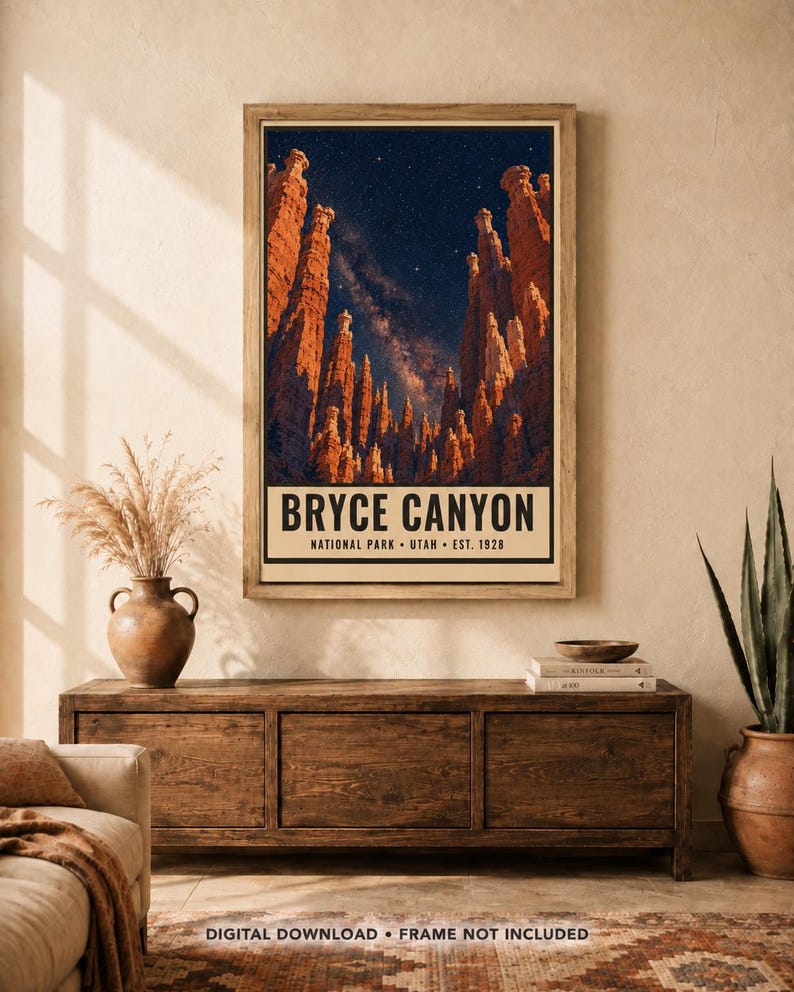 May include: A vertical rectangular wall art print featuring a night sky filled with stars above the orange rock formations of Bryce Canyon. The text at the bottom reads BRYCE CANYON NATIONAL PARK UTAH EST. 1928 in a bold, black sans-serif font.