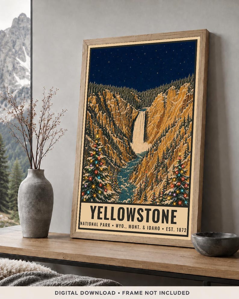 May include: A framed poster print of Yellowstone National Park featuring a waterfall, rocky canyon walls, and two evergreen trees decorated with colorful Christmas lights under a starry night sky, with the text Yellowstone National Park Wyo. Mont. & Idaho Est. 1872.