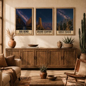 May include: Three vertical wall art prints featuring night sky landscapes of Big Bend, Grand Canyon, and Great Basin National Parks. Each print displays a starry galaxy above natural rock formations and includes text identifying the park name.