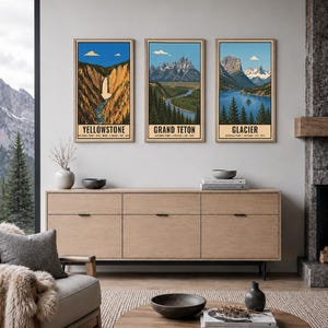 Peut inclure: Trois affiches murales verticales dans des cadres en bois clair repr&eacute;sentant des illustrations des parcs nationaux de Yellowstone, Grand Teton et Glacier. Chaque impression montre un paysage avec montagnes, for&ecirc;ts et eau, avec le nom du parc.