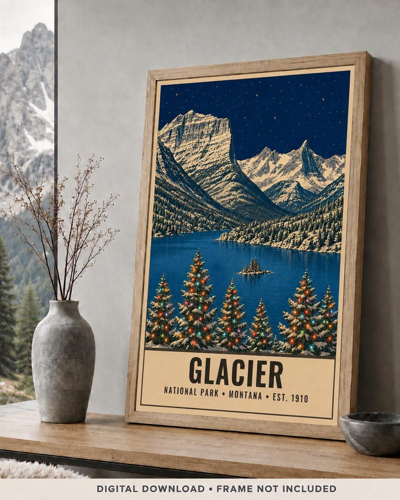 May include: A framed vertical poster featuring a night landscape of Glacier National Park, Montana. The artwork depicts snow-capped mountains, a dark blue lake, and evergreen trees decorated with colorful lights. Text reads GLACIER NATIONAL PARK MONTANA EST. 1910.