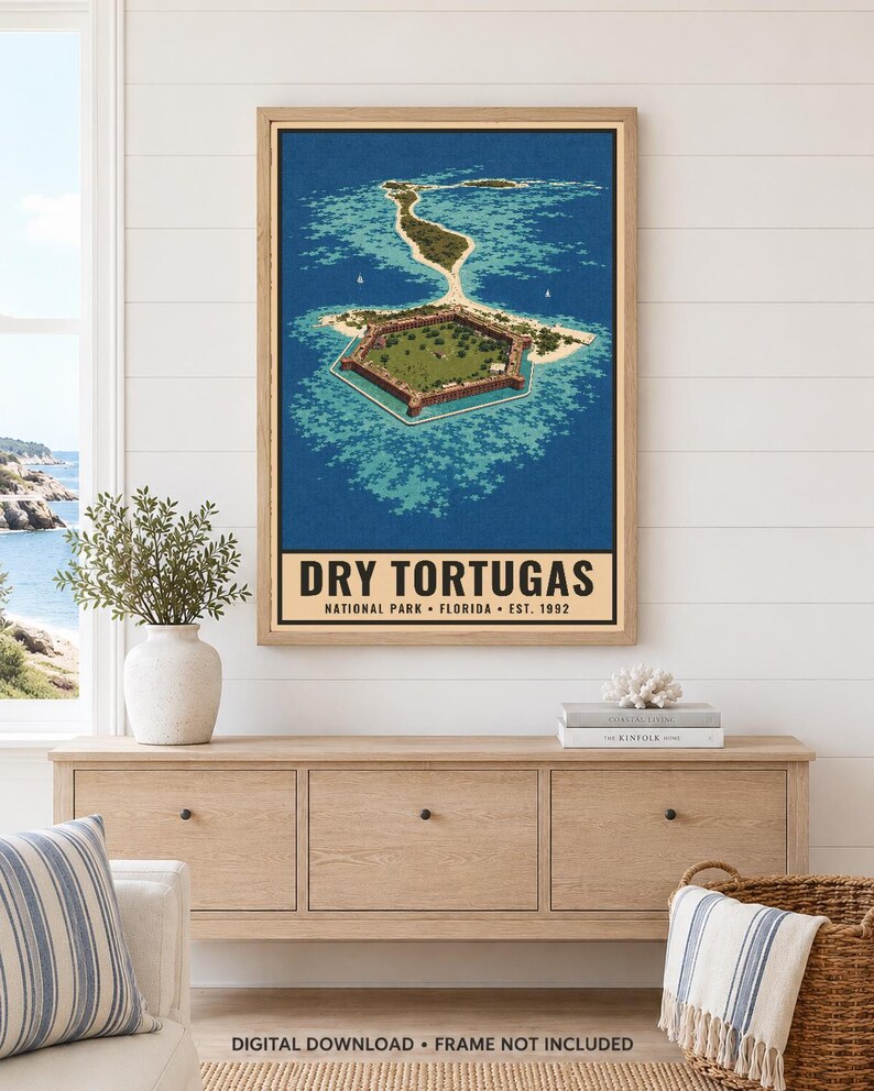 May include: A framed vertical poster featuring an aerial illustration of the hexagonal Fort Jefferson surrounded by turquoise water and sandy islands. The text reads DRY TORTUGAS NATIONAL PARK FLORIDA EST. 1992. The print is displayed in a light wood frame.