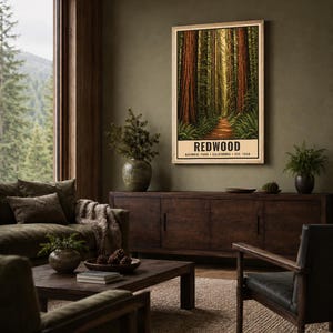May include: A vertical rectangular wall art print featuring a forest of tall redwood trees with a dirt path leading into the distance. The text at the bottom reads REDWOOD NATIONAL PARK CALIFORNIA EST. 1968 in black capital letters on a cream background.