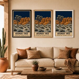 May include: Three identical vertical wall art prints featuring a Joshua Tree National Park landscape at night with orange rock formations, a starry sky, and desert vegetation. Each print includes the text JOSHUA TREE NATIONAL PARK CALIFORNIA EST. 1994.
