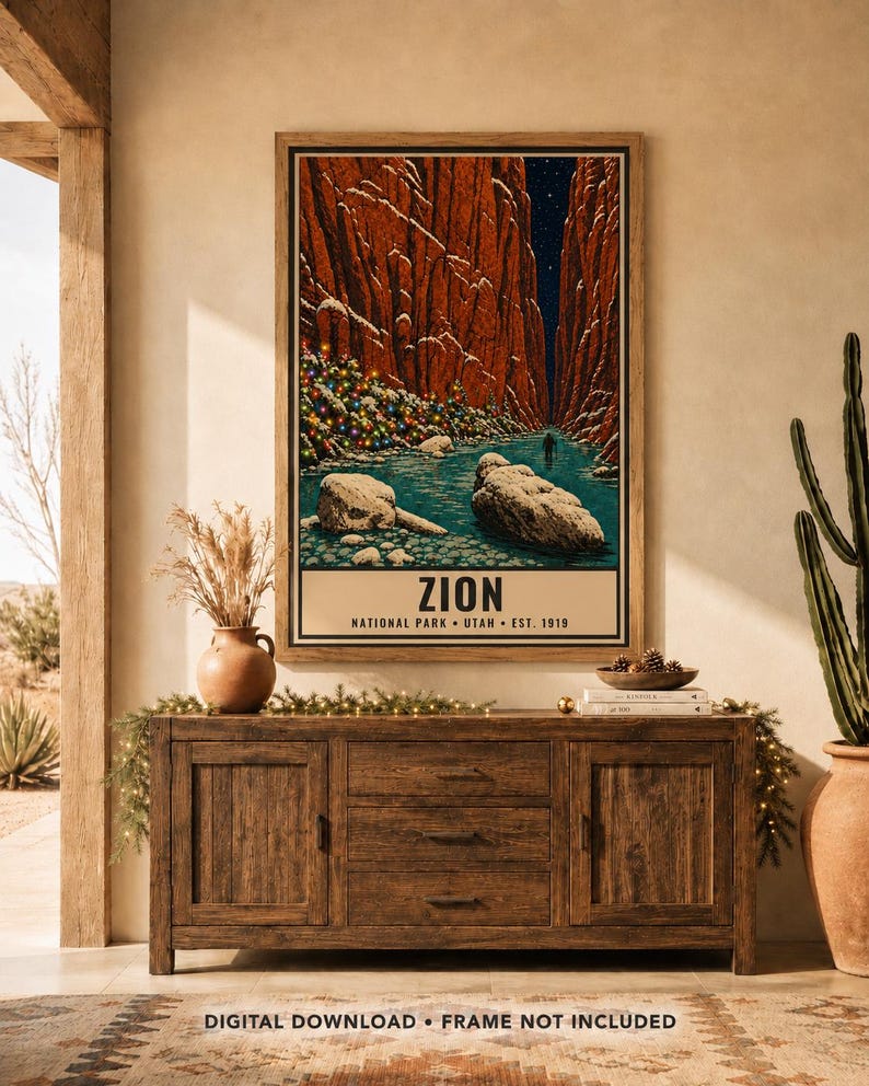May include: A vertical wall art print featuring a stylized illustration of Zion National Park with red canyon walls, a blue river, and a tree decorated with colorful lights. The text reads ZION NATIONAL PARK UTAH EST. 1919 at the bottom.