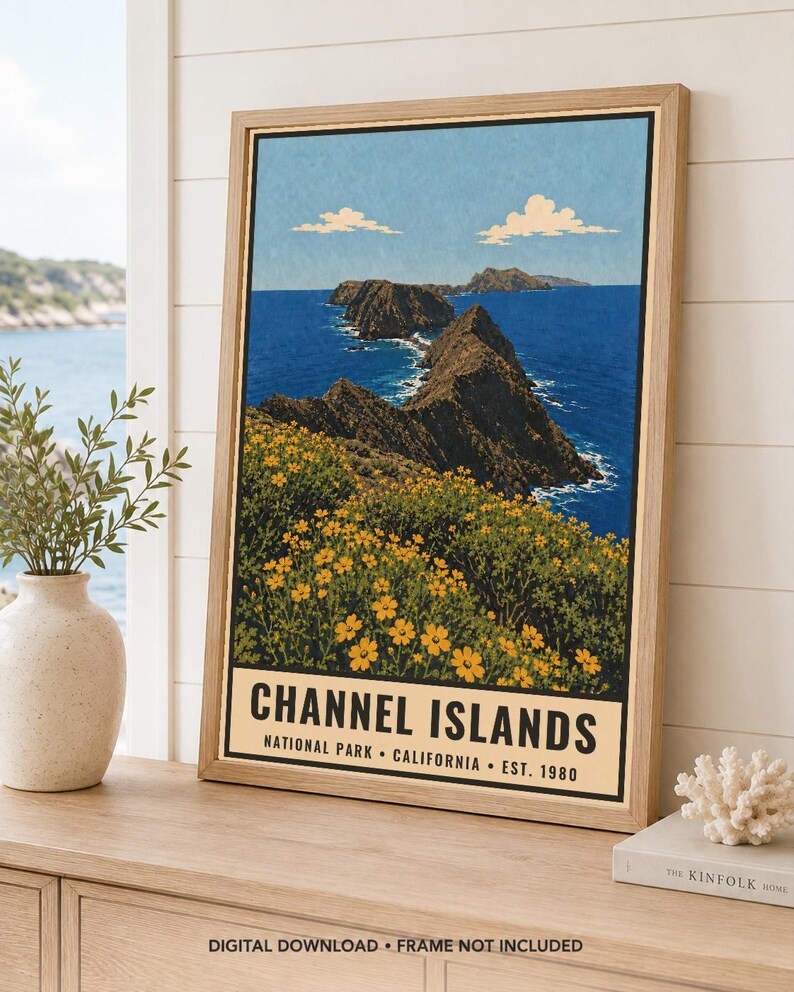 May include: A framed vertical poster featuring a landscape illustration of Channel Islands National Park, California. The artwork depicts rocky cliffs, deep blue ocean waters, and yellow wildflowers under a light blue sky with white clouds.