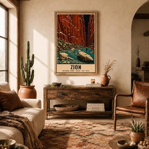 May include: A framed vertical wall art print depicting a narrow canyon with tall red rock walls, a blue river, and large boulders in the foreground. The text at the bottom reads ZION NATIONAL PARK UTAH EST. 1919 in a clean, bold, black sans-serif font.