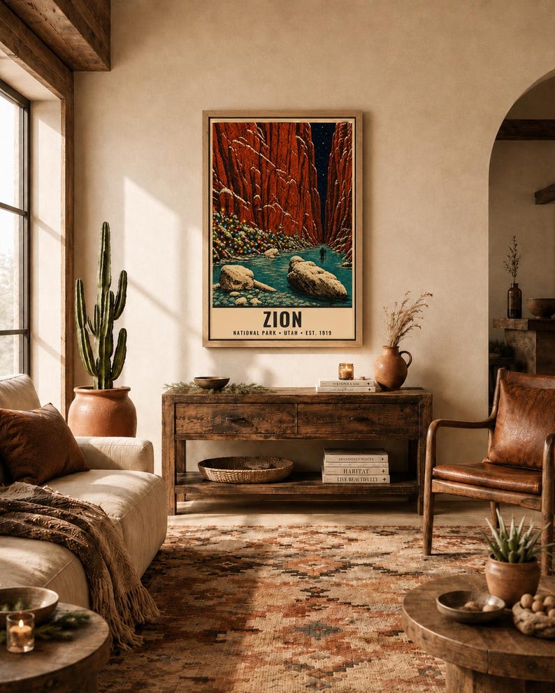 May include: A framed vertical wall art print depicting a narrow canyon with tall red rock walls, a blue river, and large boulders in the foreground. The text at the bottom reads ZION NATIONAL PARK UTAH EST. 1919 in a clean, bold, black sans-serif font.