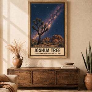 May include: A vertical rectangular wall art print featuring a night sky with a visible Milky Way galaxy above a desert landscape with a Joshua tree and rock formations. The text reads JOSHUA TREE NATIONAL PARK CALIFORNIA EST. 1994.