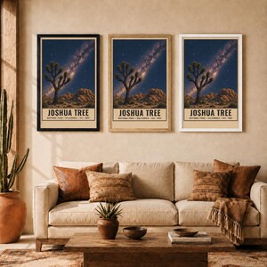 May include: Three vertical wall art prints featuring a Joshua Tree National Park landscape at night with a starry sky and Milky Way. Each print displays the text JOSHUA TREE NATIONAL PARK CALIFORNIA EST. 1994 in a black font on a cream background.