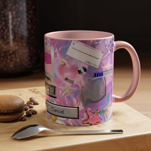 May include: A pink ceramic mug featuring a nostalgic computer-themed graphic print. The design includes a pop-up window with the text 'Are you sure you want to delete all feelings?', a 'Start' button, a loading bar, and a 'Cancel' button.