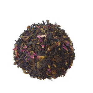 May include: A close-up of a pile of loose leaf tea with black tea leaves, dried rose petals, and other herbs.