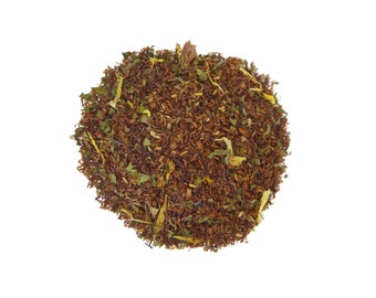 May include: A close-up of a blend of loose leaf tea with red, green, and yellow pieces.